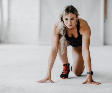 Body care in middle age and start workout at home or gym Body care in middle age and start workout at home or gym. Confident mature lady athlete or trainer in sportswear and fitness tracker ready to run in gym or home interior in morning, free space